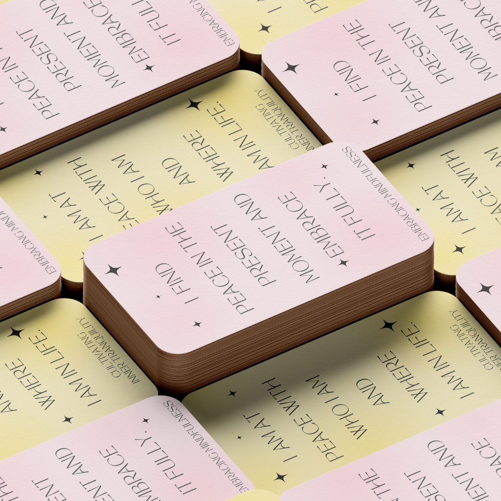 Close-up of stacked cards: “Pastel pink and yellow Inner Peace affirmation cards with star accents and messages about acceptance and the present moment.”