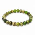 8mm chrysoprase stretch bracelet with polished green and yellow-tan round beads and dark mottled patterns on white
