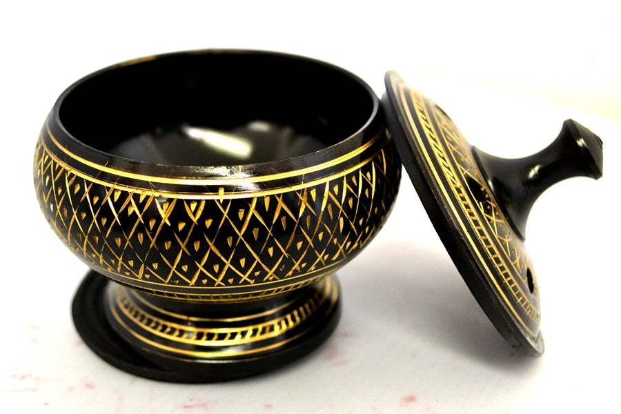 Crystal Fairy Patch black carved brass incense burner with intricate gold-tone etched patterns, matching lid, and wooden coaster.