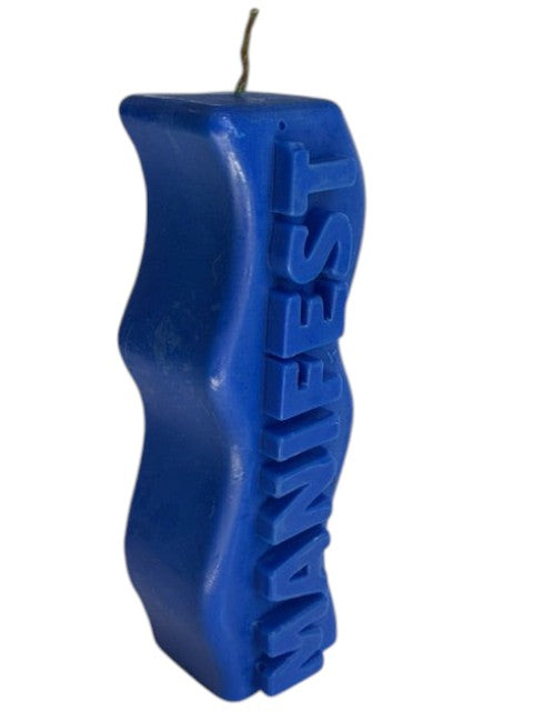 Crystal Fairy Patch blue sculptural candle with a wavy silhouette and raised MANIFEST lettering for meditation and decor.
