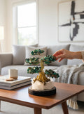 Crystal Fairy Patch handcrafted Chrysocolla bonsai tree with gold trunk on a raw quartz and pyrite base in a modern living room.