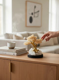 Crystal Fairy Patch Citrine Bonsai Tree with golden crystal leaves on a raw quartz and pyrite base, displayed on a wooden table.