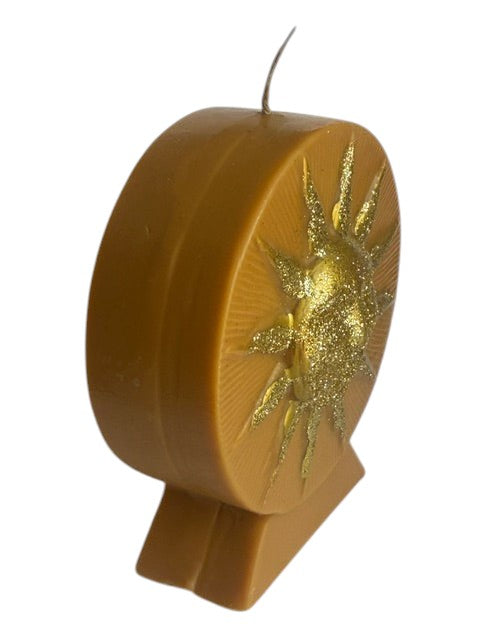Crystal Fairy Patch Golden Sun handcrafted wax candle in honey yellow with embossed sun face and shimmering gold glitter accents.