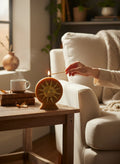 Crystal Fairy Patch Golden Sun handcrafted wax candle with gold glitter accents, lit on a rustic wooden table in a cozy living room