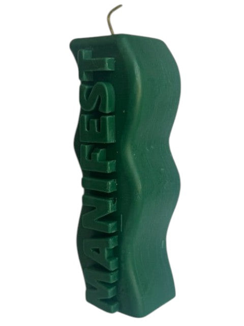 Crystal Fairy Patch green sculptural candle with wavy silhouette and raised MANIFEST lettering for meditation and decor