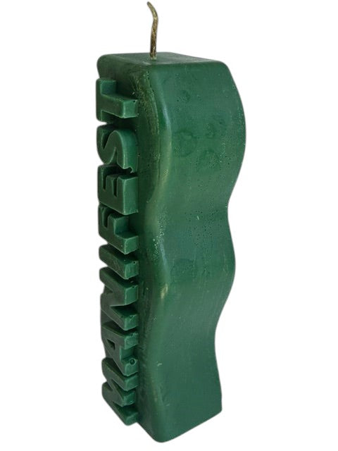 Crystal Fairy Patch green handcrafted sculptural candle with a wavy silhouette and raised MANIFEST lettering for meditation.