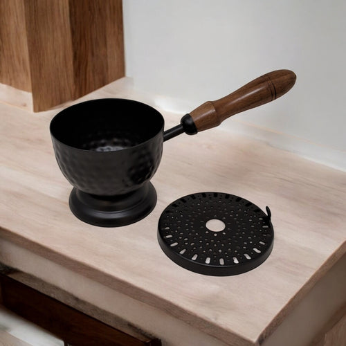 Crystal Fairy Patch 9-inch matte black iron cauldron incense burner with hammered texture, wooden handle, and perforated lid.