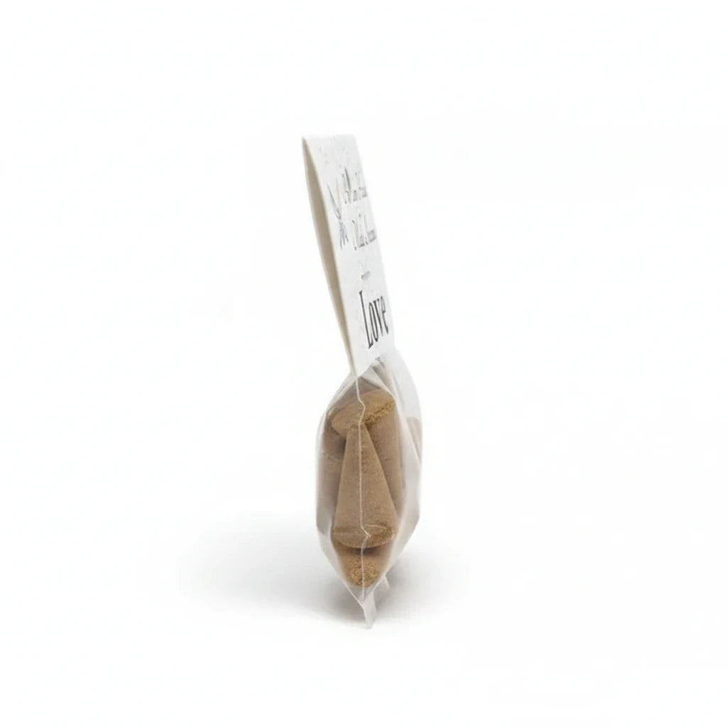 Crystal Fairy Patch Love premium hand-made cone incense in a clear plastic bag with a white label, side view.