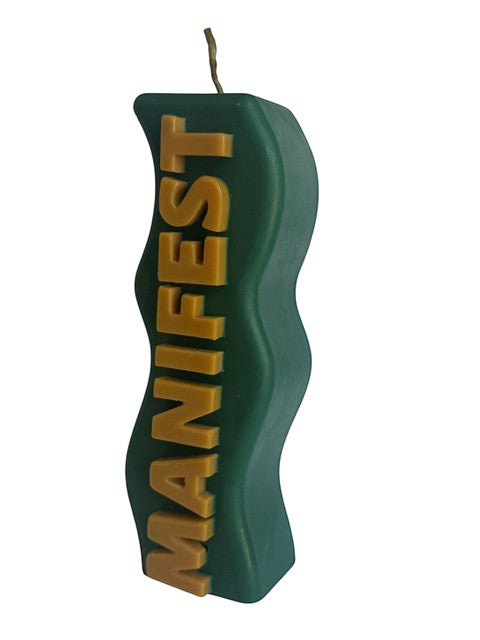 Crystal Fairy Patch green wavy pillar candle with beige raised MANIFEST lettering for meditation and home decor.