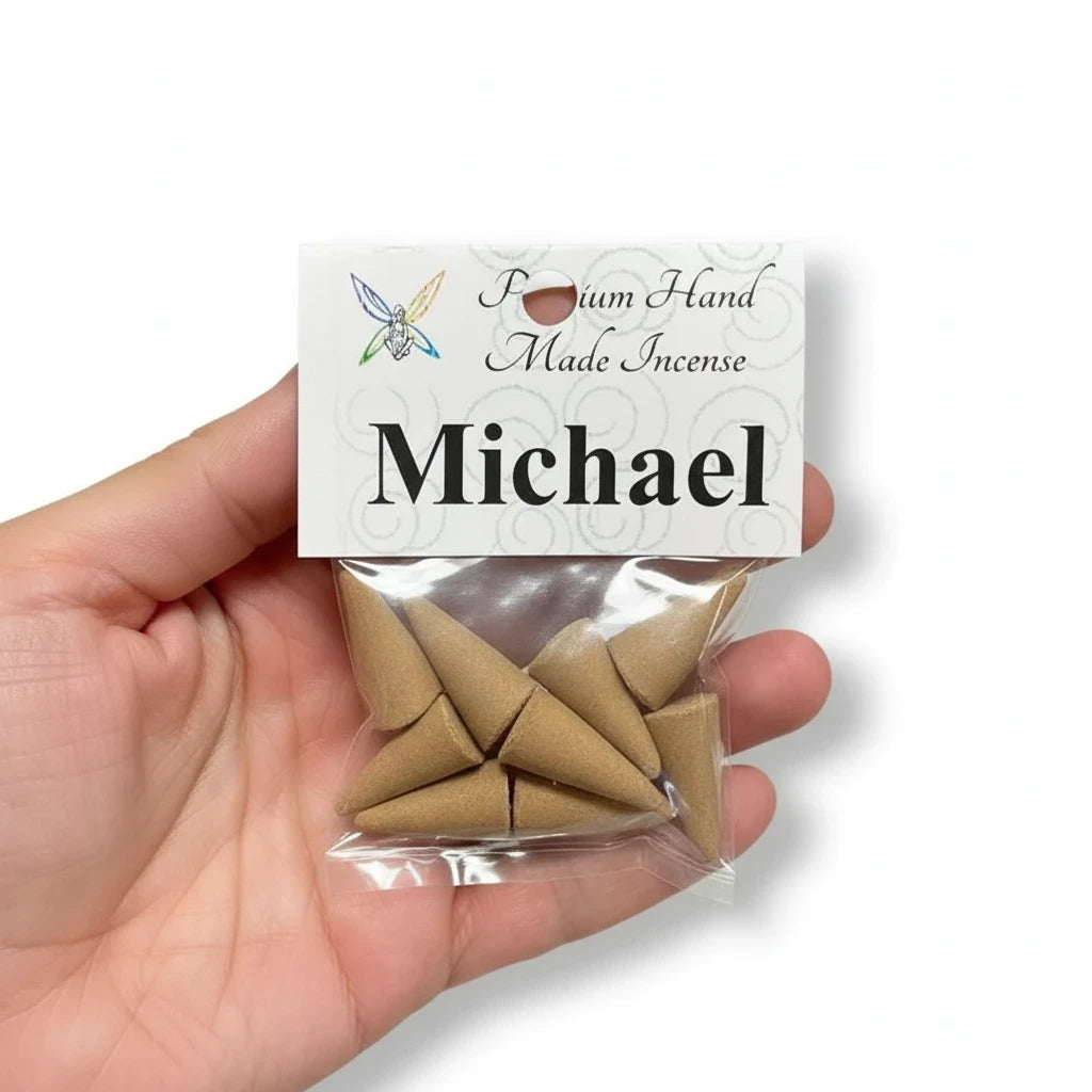 Crystal Fairy Patch Michael premium hand-made cone incense in a clear plastic bag held in a hand for spiritual practice.