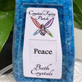 Crystal Fairy Patch Peace bath salts in a clear bottle with vibrant blue crystals for peace.