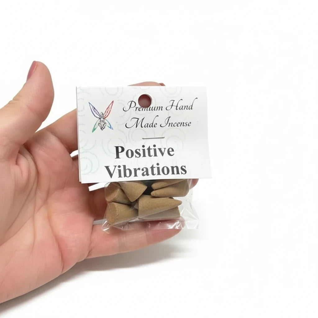 Crystal Fairy Patch Positive Vibrations premium hand-made cone incense in a small clear plastic bag held in a hand