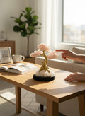 Crystal Fairy Patch Rose Quartz Bonsai Tree with gold trunk and quartz pyrite base on a wooden table in a sunlit living room