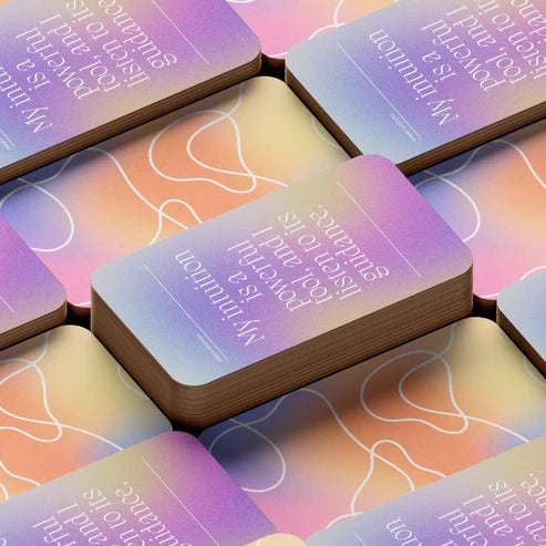 Close-up of stacked cards: Close-up of Spiritual Growth Affirmations cards with pastel gradients, white lettering, and abstract line art.