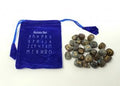 Set of stone runes with a blue drawstring bag on a white background