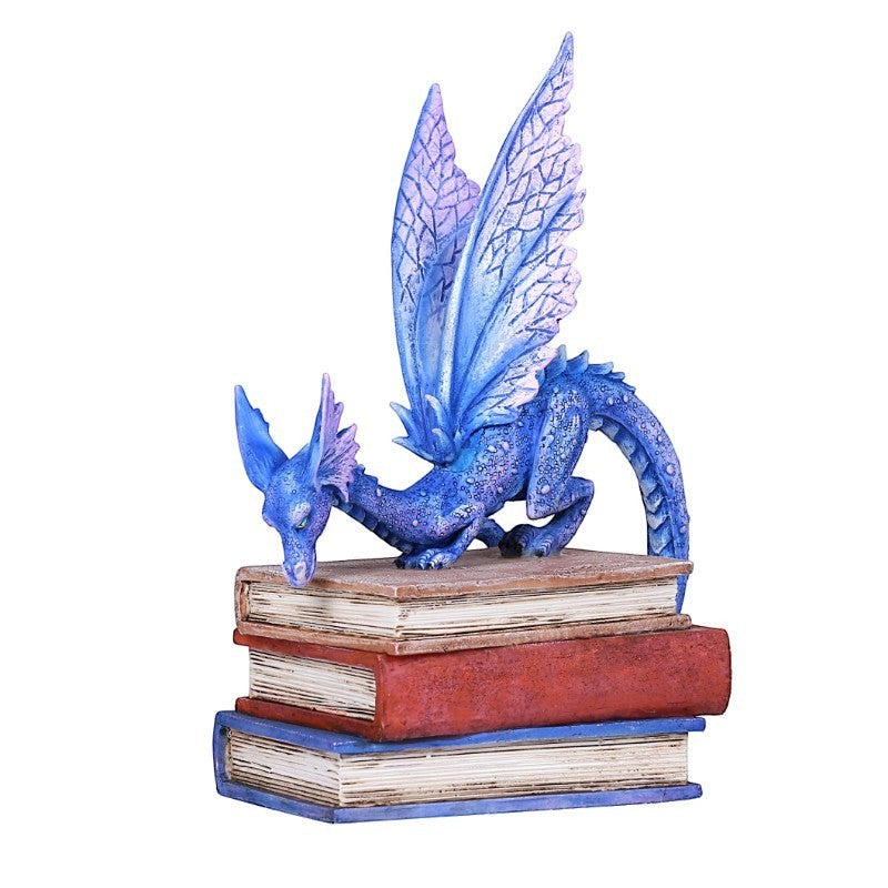 Indigo Book Dragon Figurine with iridescent scales and purple wings perched on antique books.