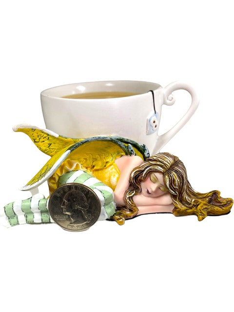 My Store Amy Brown Chamomile Fairy Tea Figurine, sleeping fairy with yellow wings and green striped leggings resting on a teacup.
