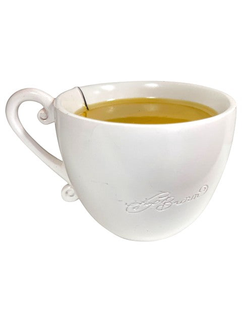 My Store Amy Brown Chamomile Fairy Tea Figurine, white ceramic teacup filled with golden chamomile tea.