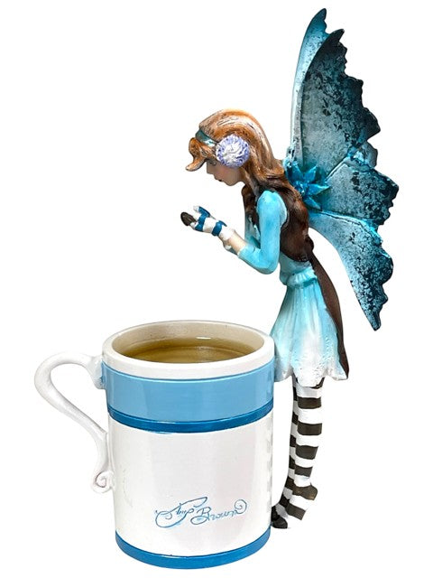 My Store Amy Brown Hot Cocoa Faery Cup with blue and white design, filled with hot beverage.