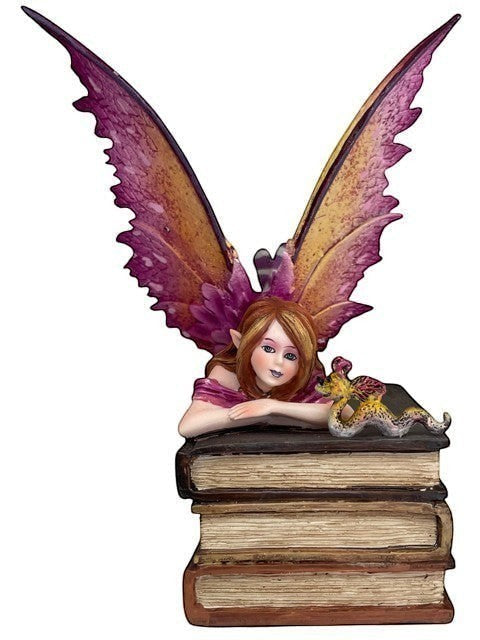 My Store Book Club Fae figurine of a fairy with purple and gold wings resting on a stack of old books.