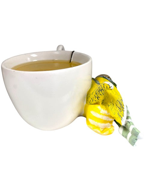 My Store Amy Brown Chamomile Fairy Tea Figurine, a yellow bird with striped tail perched on a white teacup filled with tea.