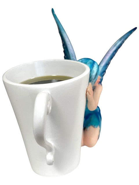 My Store white coffee mug with a blue-haired fairy peeking over the edge, holding the mug.