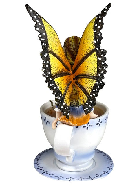 My Store Warm Toes Faery figurine with monarch butterfly wings sitting in a teacup.