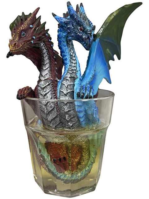 My Store Drinks and Dragons Series "Gin and Tonic" dragon figurine by Stanley Morrison. Two dragons, one red and one blue, emerge from a clear glass filled with yellow liquid.