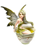 My Store Green Tea Fairy figurine by Amy Brown Art, sitting in a teacup with light green liquid.