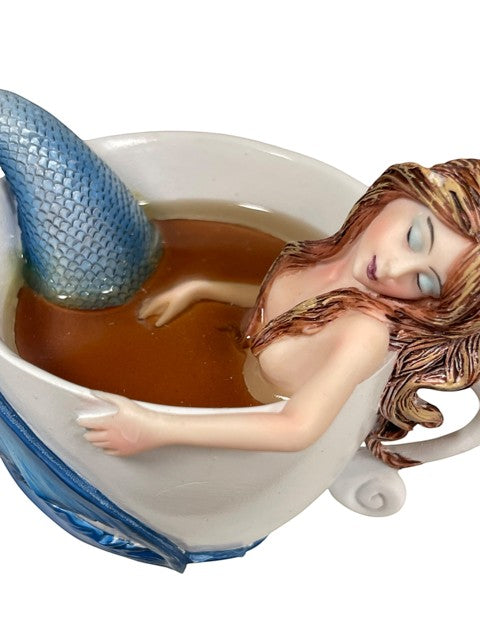 My Store Amy Brown "Relaxing Mermaid" 2015 figurine of a mermaid relaxing in a teacup filled with brown liquid.