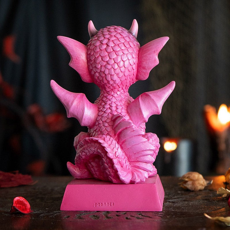 My Store pink dragon figurine with intricate scales, wings, and horns, sitting on a base with a quote. Made of resin.