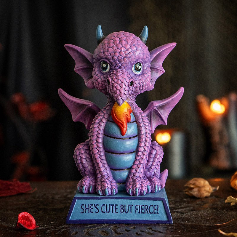 My Store purple dragon figurine with blue accents, wings spread, and flame detail. Inscribed with "She's Cute But Fierce!"