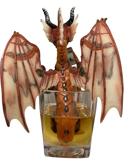 My Store Steampunk Dragon figurine with orange and cream wings, sitting in a glass of amber liquid.