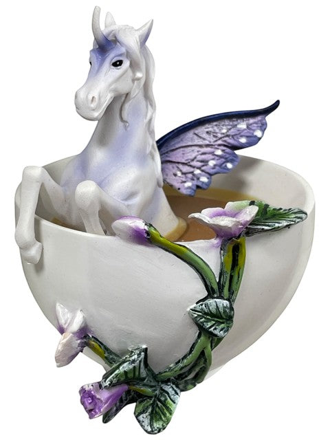 My Store white teacup figurine with a purple and white unicorn with butterfly wings inside. Decorated with purple flowers and green vines.