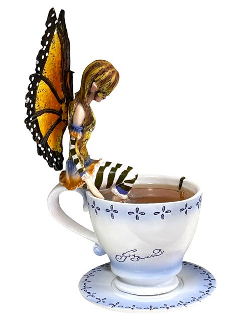 My Store Warm Toes Faery figurine with monarch butterfly wings, sitting on a teacup with striped socks.