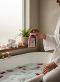 My Store Crystal Fairy Patch Attraction Bath Salts in a clear jar with pink crystals, held by a person in a white robe.