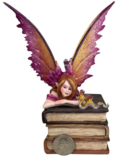 My Store Book Club Fae figurine: auburn-haired fairy with pink & gold wings on books with a small creature.