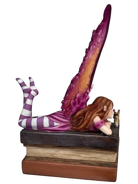 My Store Book Club Fae figurine of a fairy with purple striped socks, pink dress, and large purple wings, resting on books with a small owl.