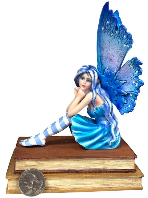My Store Book Muse Fairy Figurine with blue hair, blue butterfly wings, and striped stockings, seated on books.