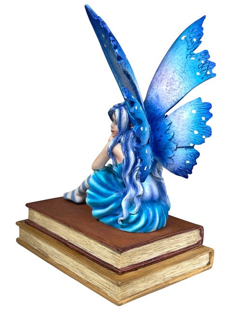 My Store Book Muse Fairy Figurine with blue hair, butterfly wings, and blue dress, seated on books.