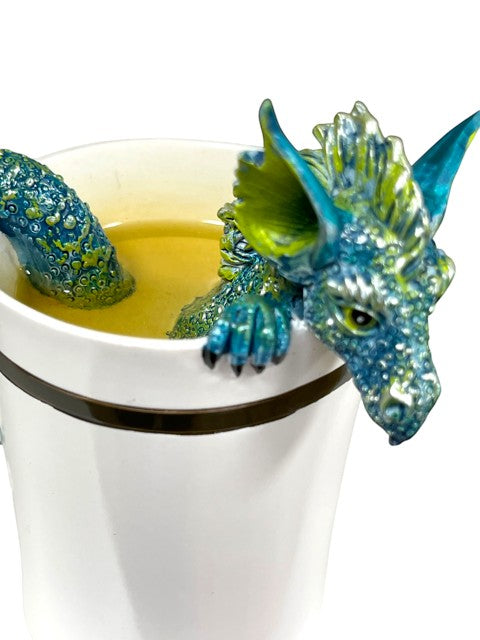My Store white ceramic mug with a teal and green dragon sculpture peeking over the rim and coiled around the handle.