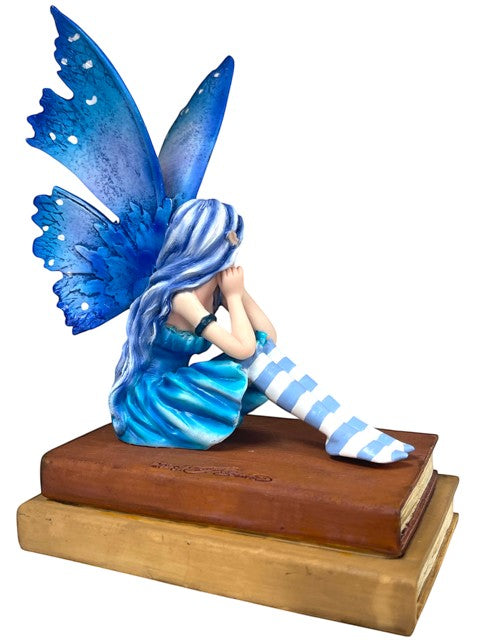 My Store Book Muse Fairy Figurine with blue hair, butterfly wings, and striped stockings, seated on books.