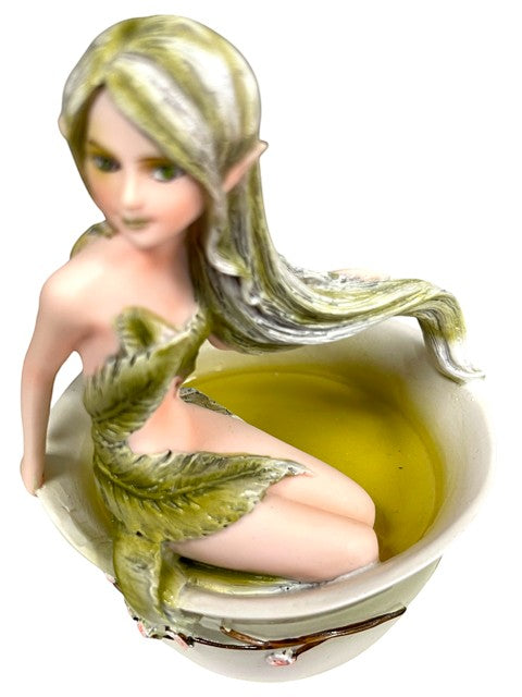 My Store Green Tea Fairy figurine, a mythical creature with long blonde hair and green eyes, sitting in a teacup filled with light green liquid.