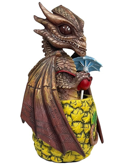 My Store Mai Tai Dragon figurine by Stanley Morrison, a brown dragon with wings, holding a red apple and a blue umbrella, standing on a pineapple base.