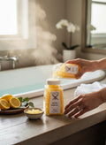 My Store Spring Equinox bath salts being poured into a jar in a steamy bathroom with lemons nearby.