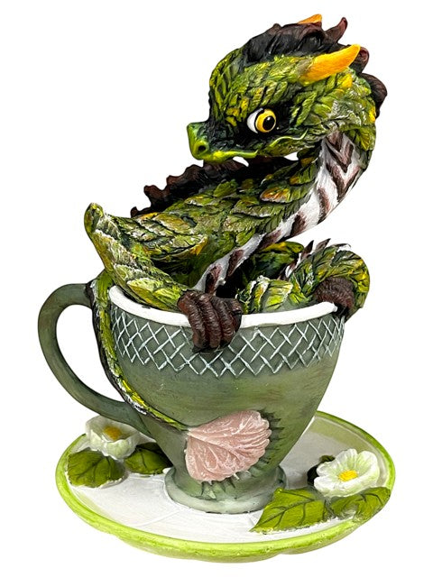 My Store green tea dragon figurine perched in a teacup with saucer, detailed scales and yellow eyes.