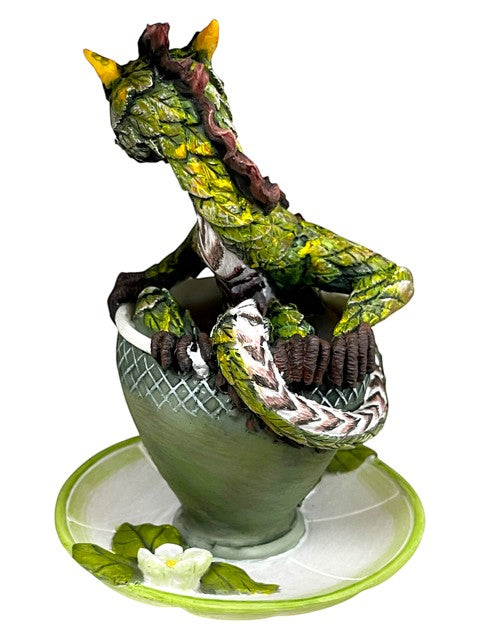 My Store Tea Dragon figurine, a green dragon with leaf-like scales coiled in a teacup with a saucer decorated with flowers.