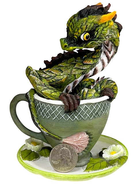 My Store green tea dragon figurine perched in a teacup with floral accents. Detailed scales and yellow eyes.