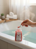 My Store Uncrossing Bath Salts in a jar with a spoon adding crystals to a steaming bath.