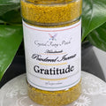 My Store Gratitude powdered incense in a clear jar with a white label. Yellow-gold granular incense.
